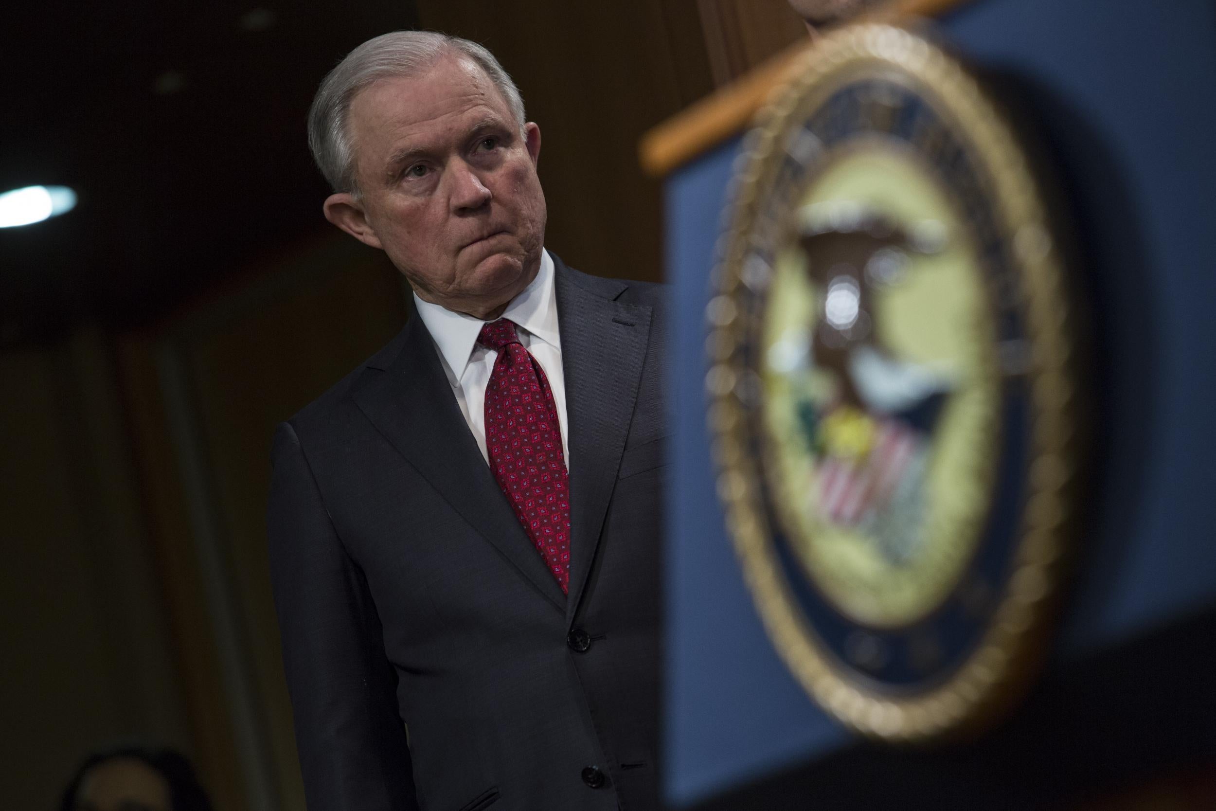 Attorney General Jeff Sessions listens during a press conference at the Department of Justice in Washington, DC