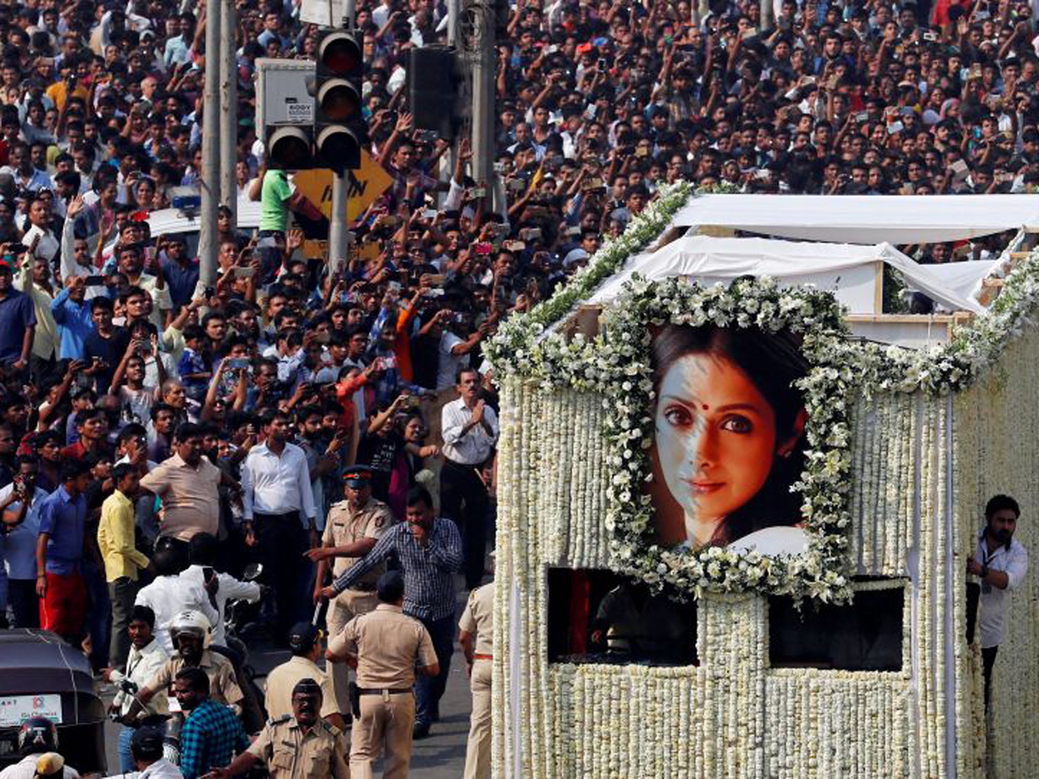 The body of Bollywood actress Sridevi is carried in a truck during her funeral procession in Mumbai