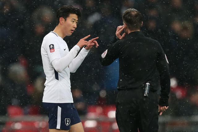 Son Heung-min tries to discuss a decision with referee Paul Tierney