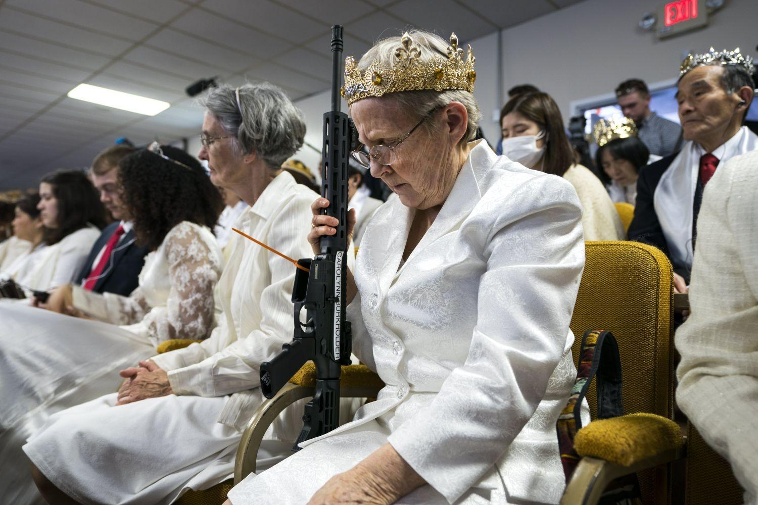 A parishioner with the Sanctuary Church holds onto her AR-15