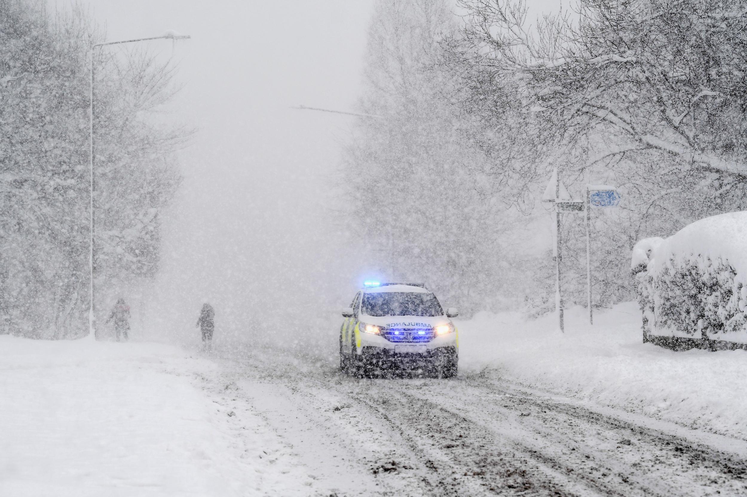 An emergency vehicle makes its way along the A813 in Balloch, Scotland