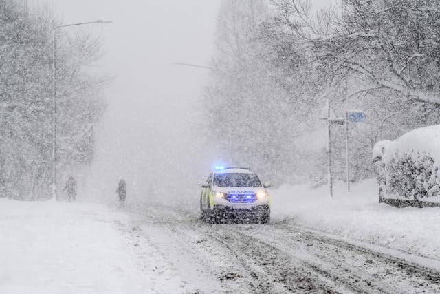 An emergency vehicle makes its way along the A813 in Balloch, Scotland