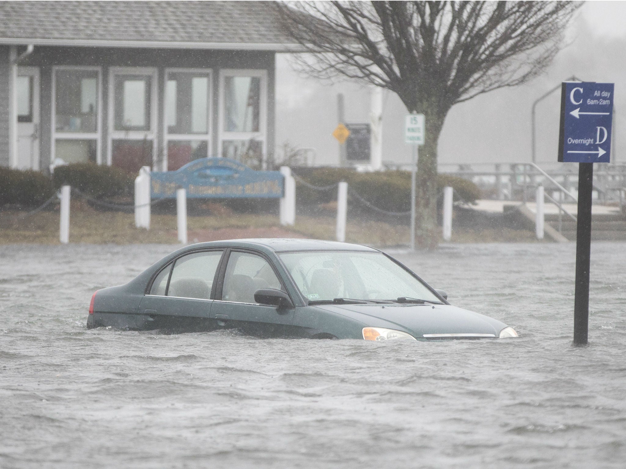 A car is submerged as the coastal storm hits Scituate, Massachusetts