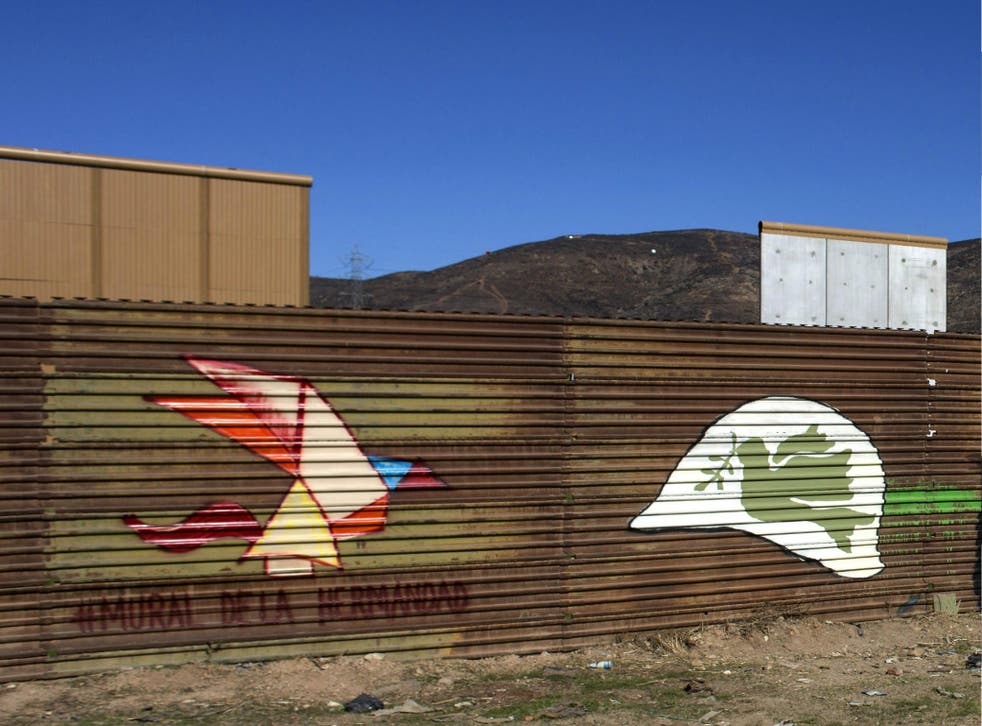 Mural painted on the border fence, on the background border wall prototypes are seen at the US-Mexico border on 22 January 2018.