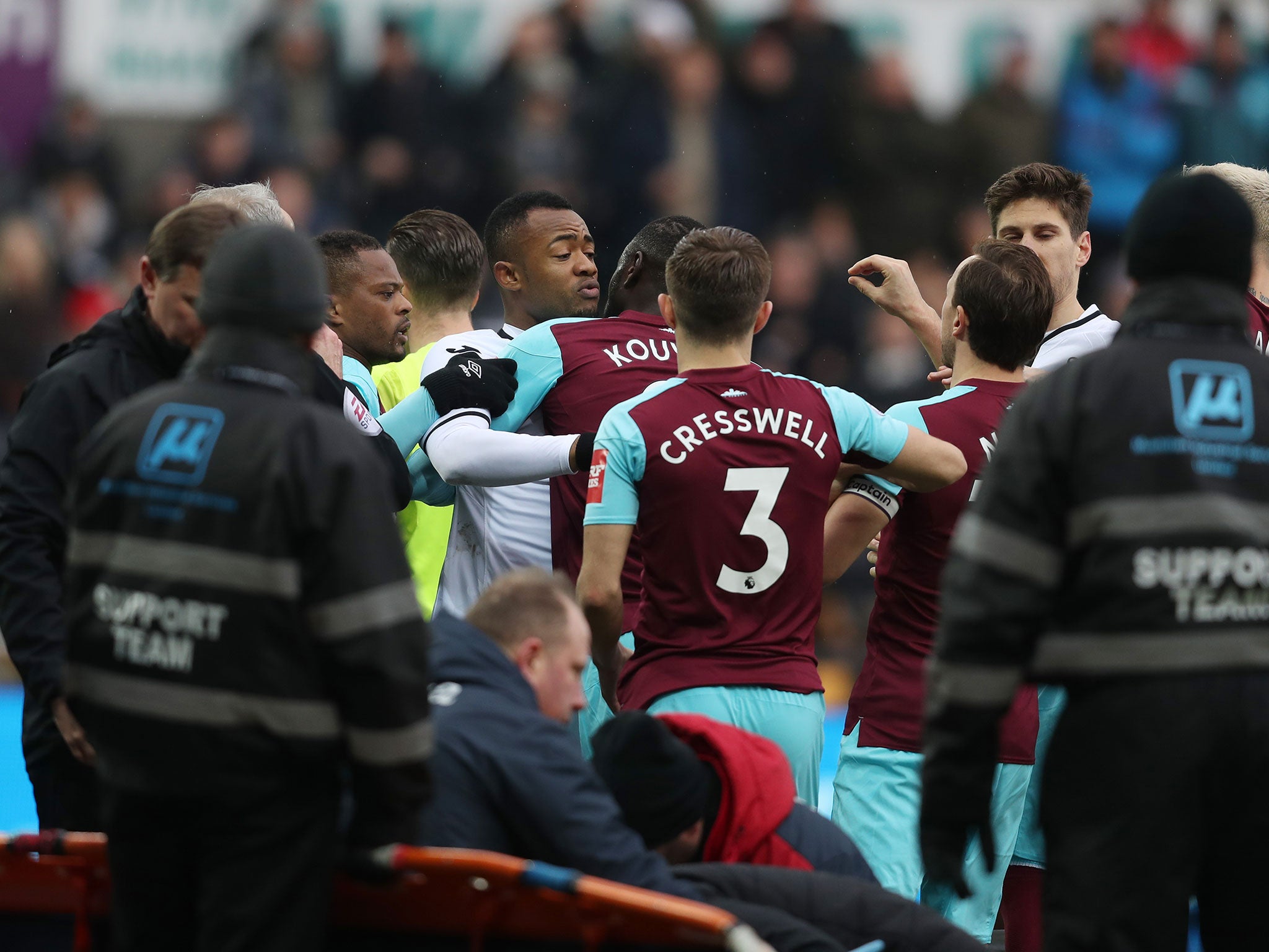 Jordan Ayew confronts Cheikhou Kouyate as Winston Reid (not pictured) receives treatment