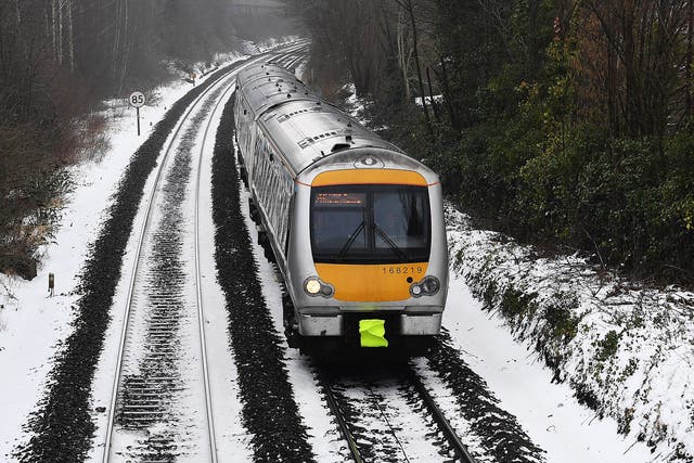 A train operates in icy conditions from High Wycombe to London.