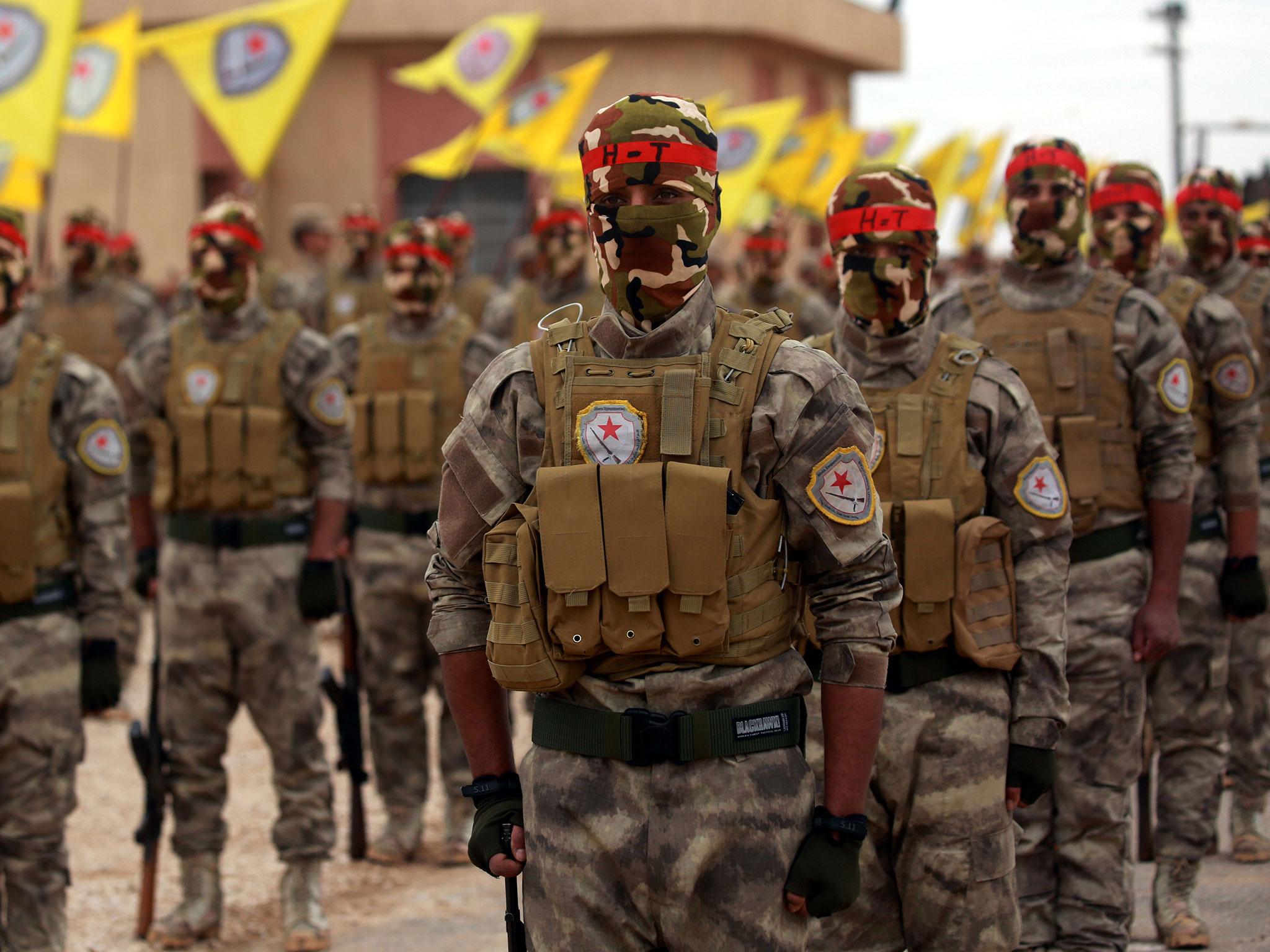 Arab and Kurdish fighters take part in a graduation ceremony in Qamishli last week. They are witnessing the Isis comeback on the front line