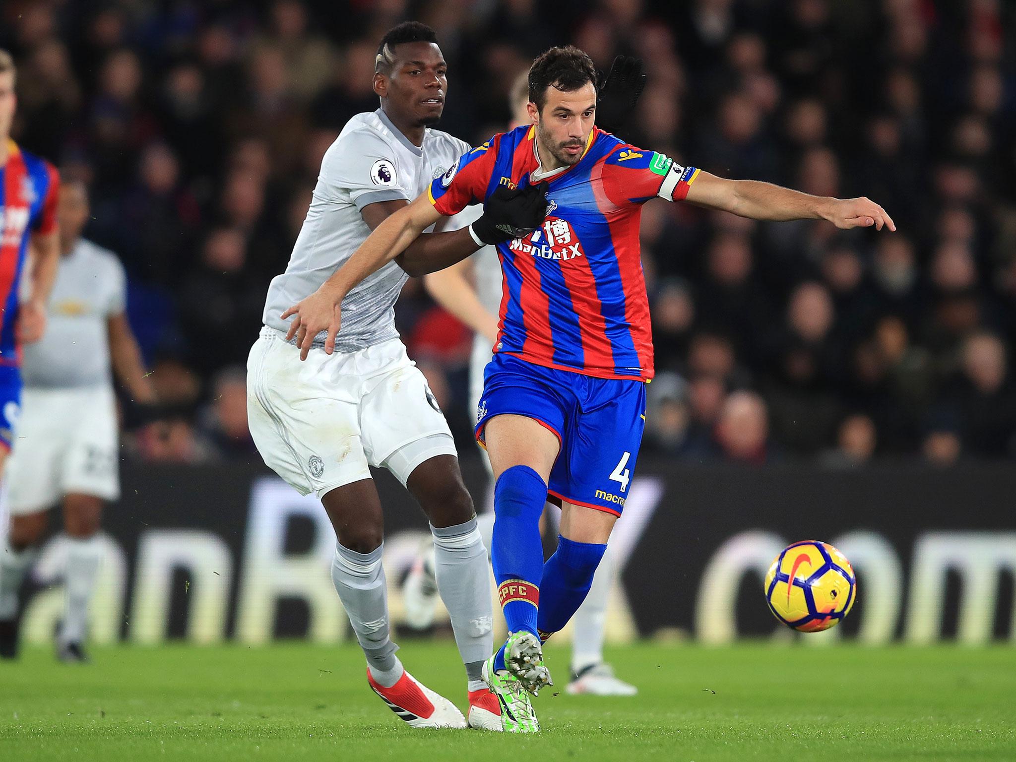 Paul Pogba tussles for possession with Luka Milivojevic
