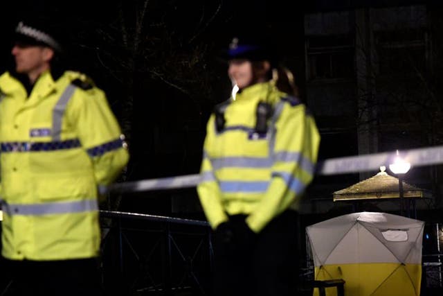 Police officers stand guard beside a cordoned-off area, after former Russian military intelligence officer Sergei Skripal