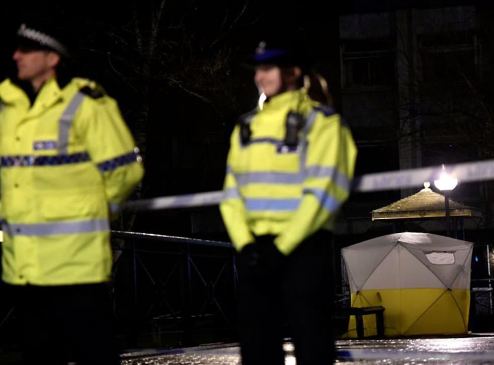 Police officers stand guard beside a cordoned-off area, after former Russian military intelligence officer Sergei Skripal