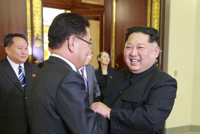 North Korean leader Kim Jong-un (R) shaking hands with South Korean chief delegator Chung Eui-yong (C) during their meeting in Pyongyang on Monday