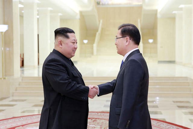 North Korean leader Kim Jong-Un (left) greets South Korean chief delegator Chung Eui-yong