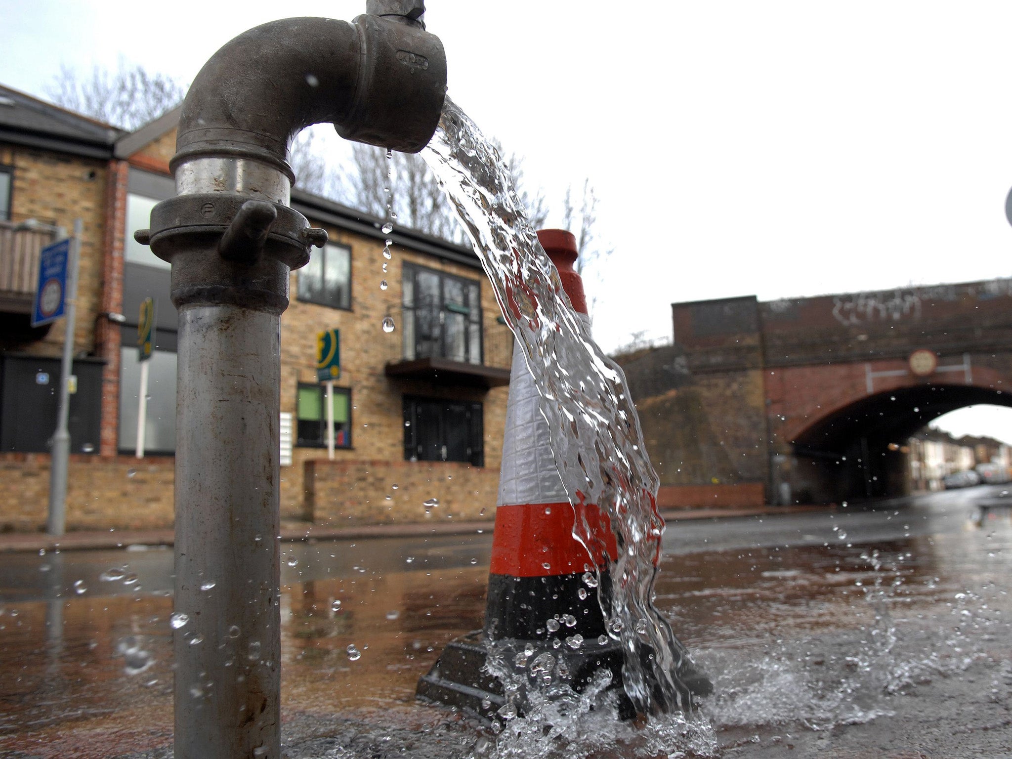 Water flows from a Thames Water standpipe after workers repaired a nearby damaged pipe