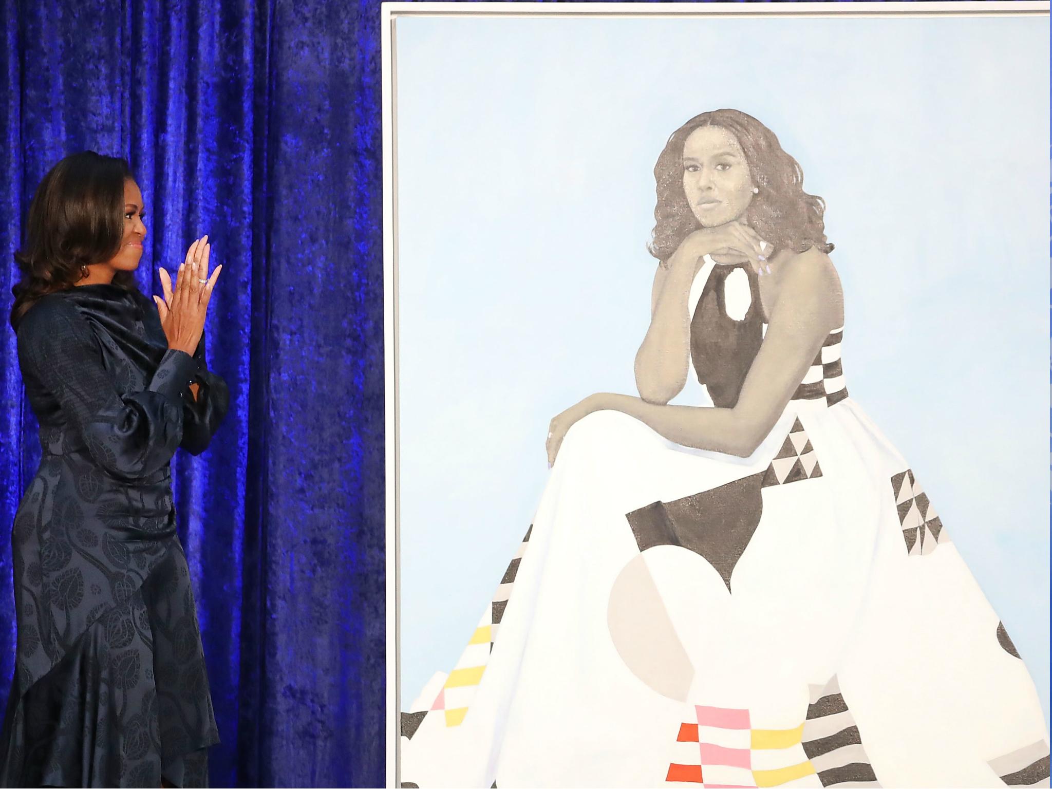Former US First Lady Michelle Obama looks at her newly unveiled portrait during a ceremony at the Smithsonian's National Portrait Gallery, on 12 February 2018 in Washington, DC.