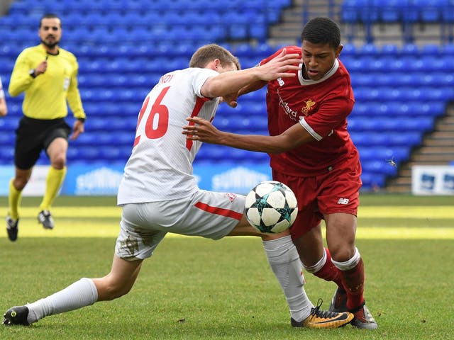 Liverpool's Rhian Brewster tussles with Leonid Mironov at Prenton Park