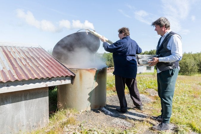 Jon Sigfusson (left) and Kjartan Olafsson load food into the communal geothermal oven