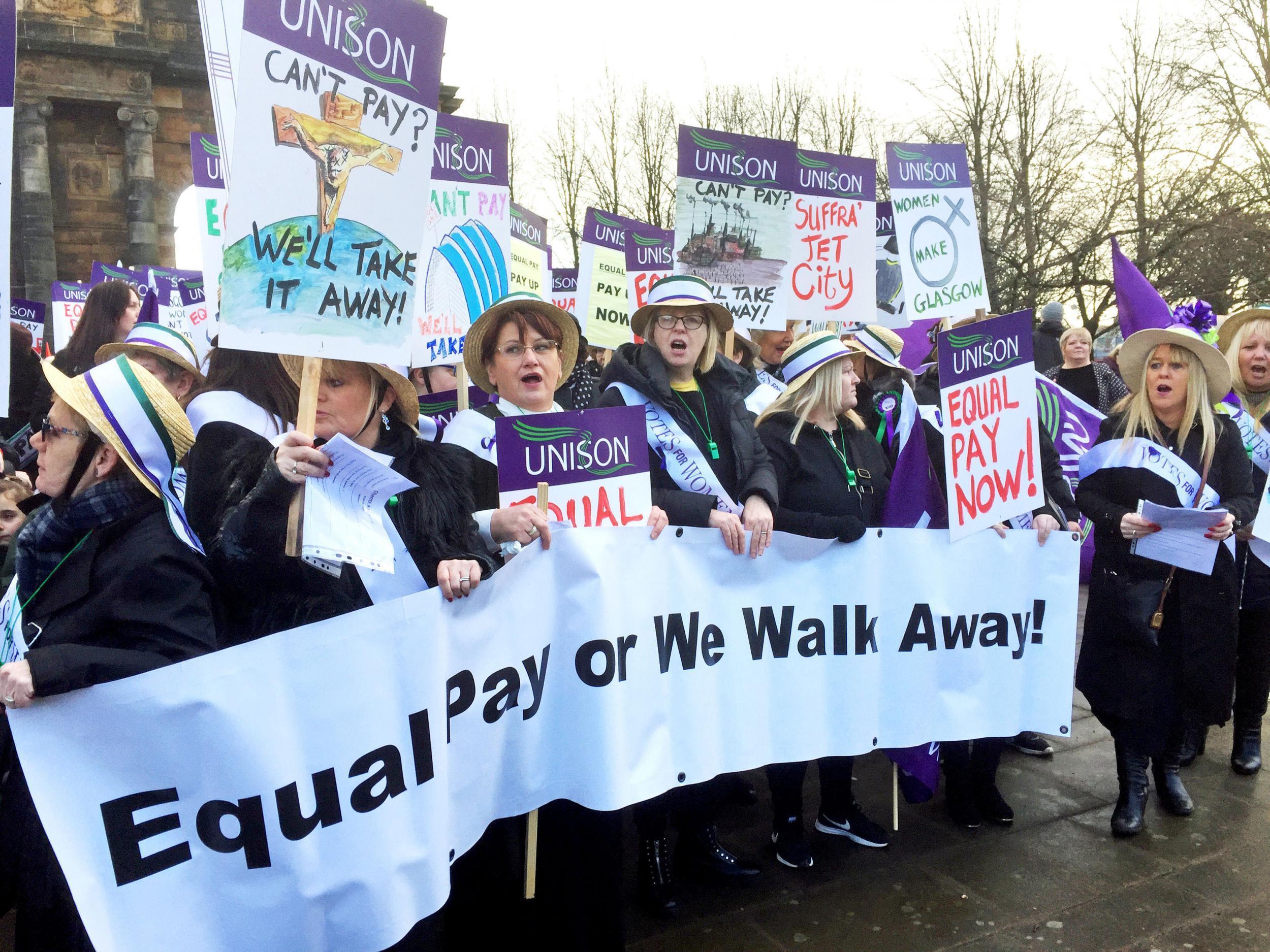 Women, some dressed as suffragettes, march through Glasgow calling for equal pay from the city council