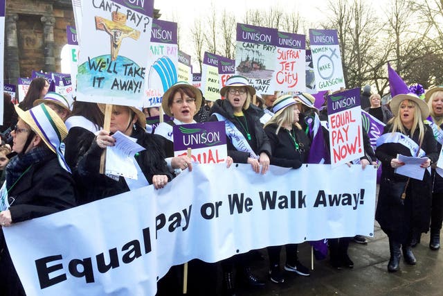Women, some dressed as suffragettes, march through Glasgow calling for equal pay from the city council