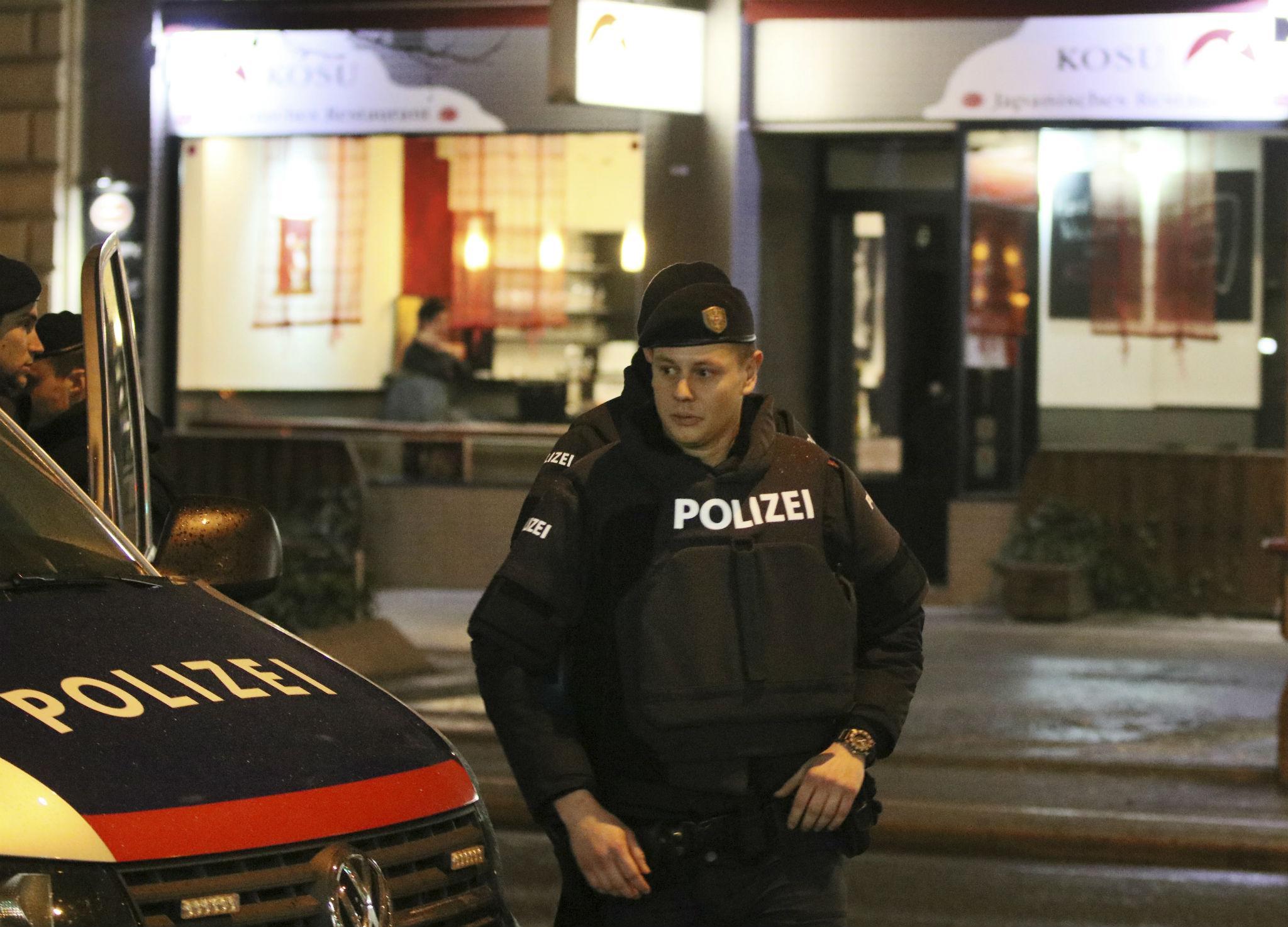 A police officers stands in front of a Japanese restaurant after several people have been injured in a knife attack on the streets of Vienna, Austria, Wednesday, March 7, 2018
