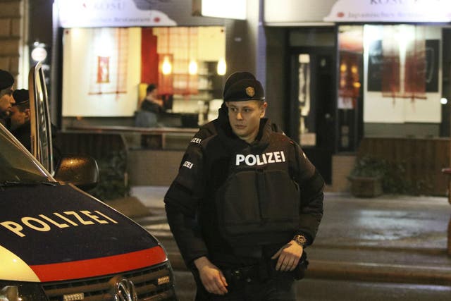A police officers stands in front of a Japanese restaurant after several people have been injured in a knife attack on the streets of Vienna, Austria, Wednesday, March 7, 2018