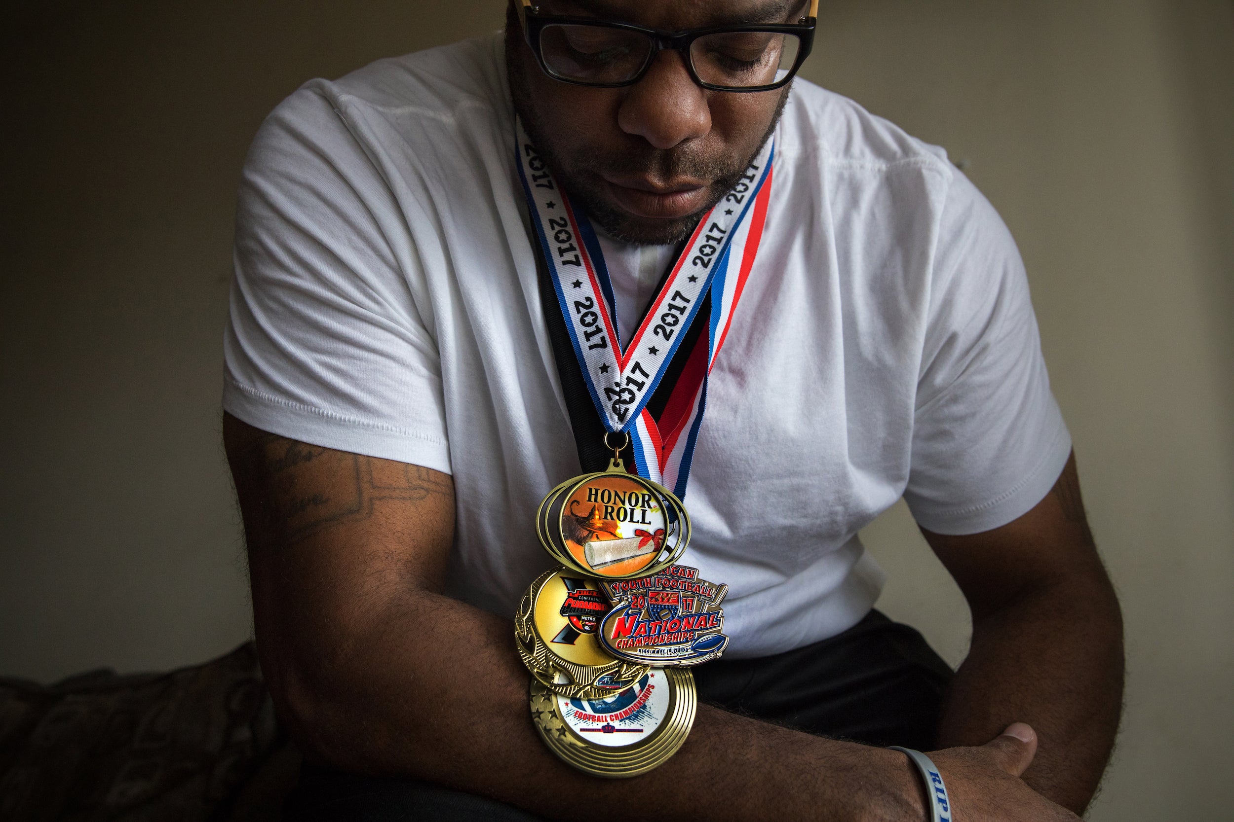 Rylan’s father, Ronald, displays sporting and academic medals won by his son