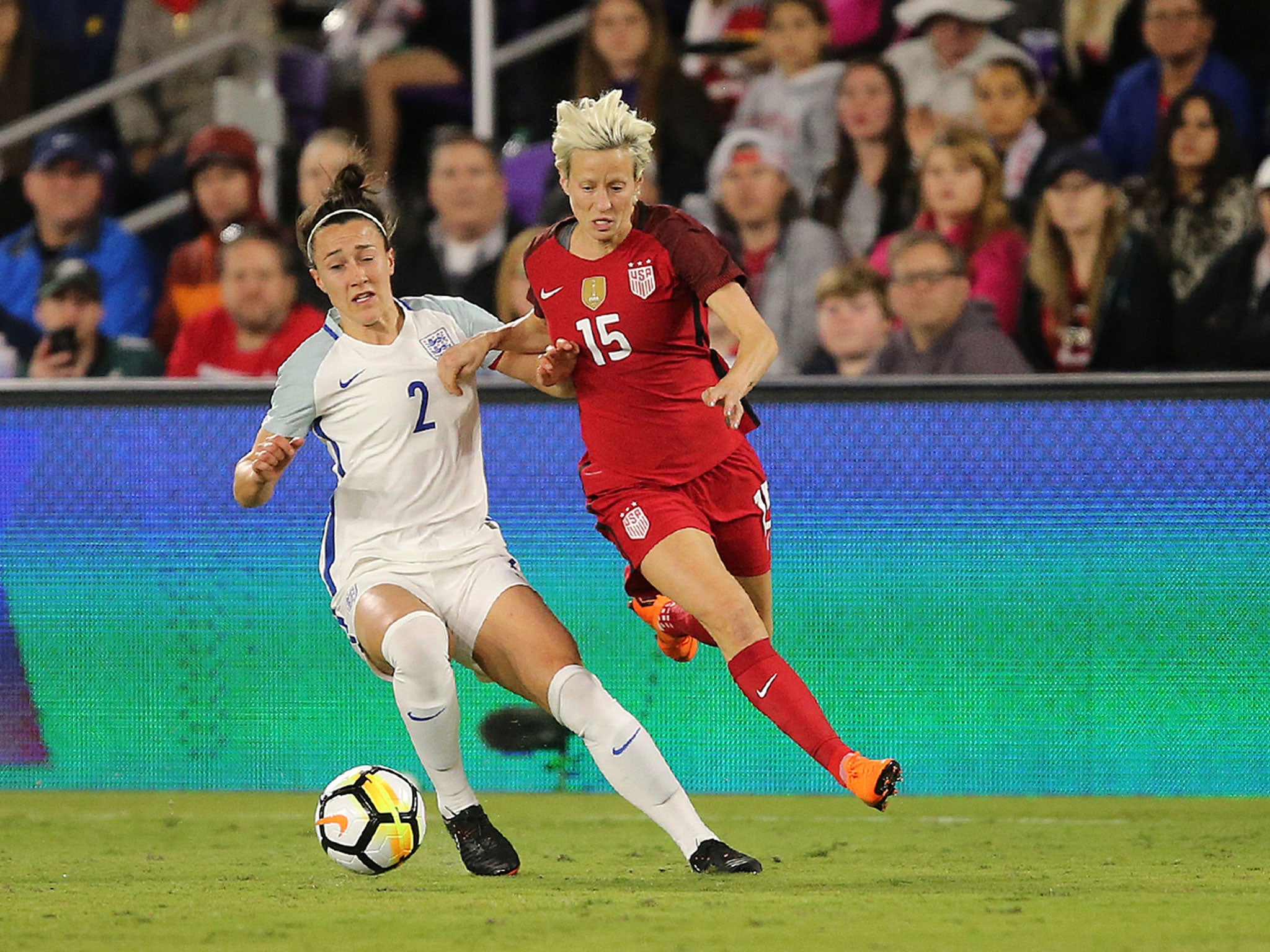 Lucy Bronze and Megan Rapinoe tussle for possession