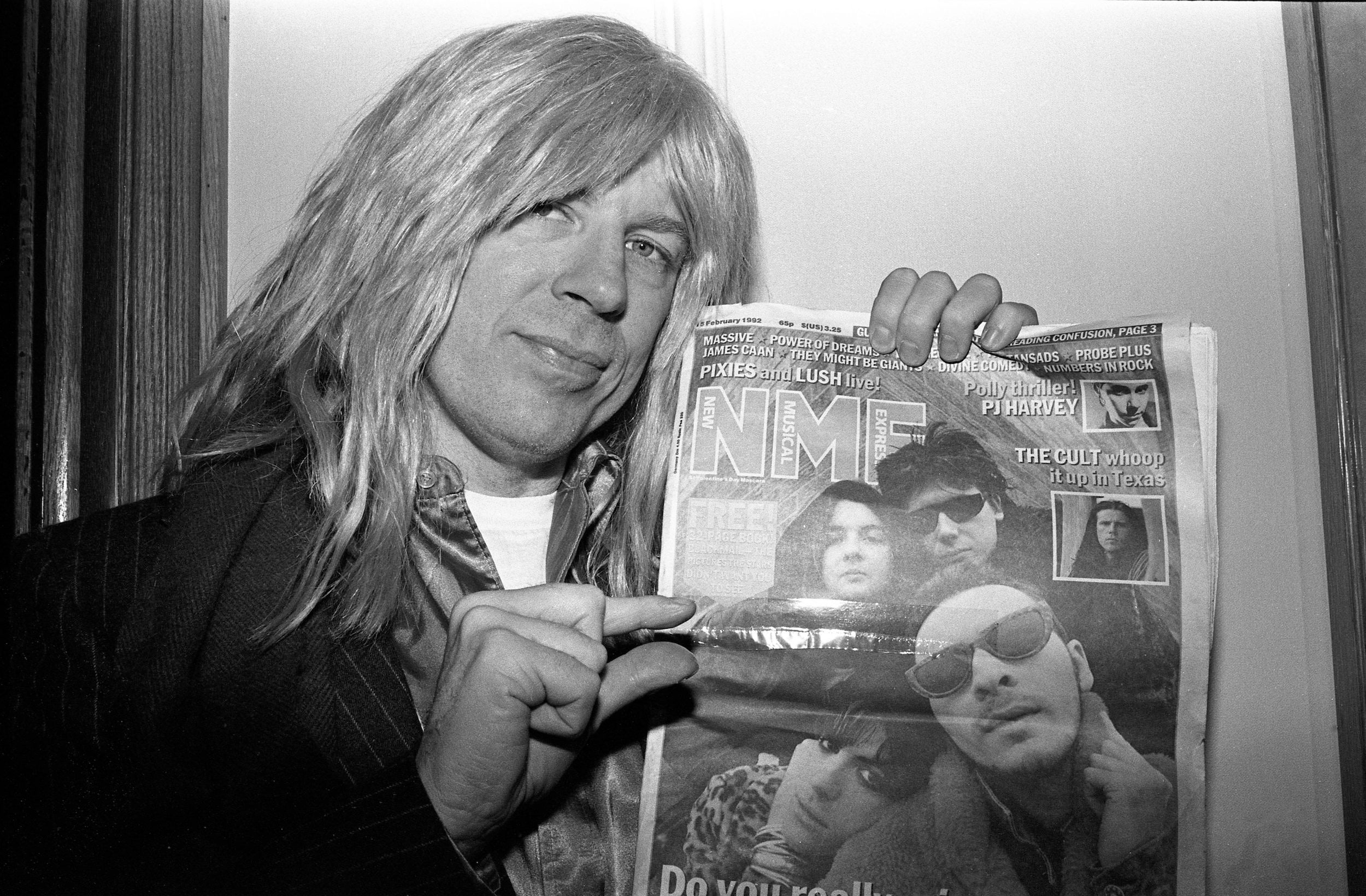 David St Hubbins (played by Michael McKean) of Spinal Tap poses with a 1992 issue