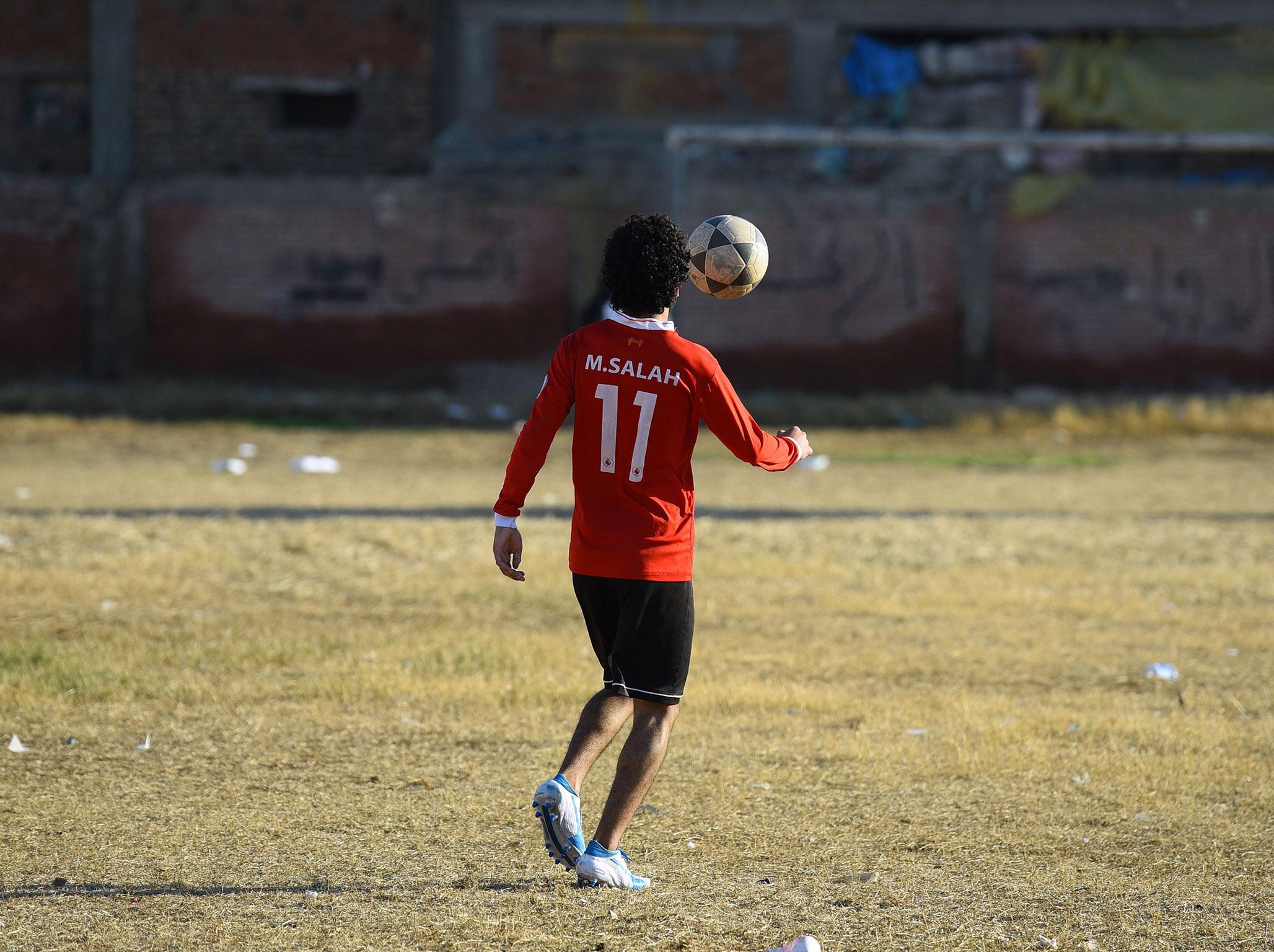 A boy plays football at the Mohamed Salah Youth Center, Nagrig