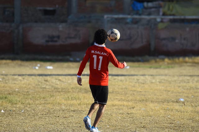 A boy plays football at the Mohamed Salah Youth Center, Nagrig