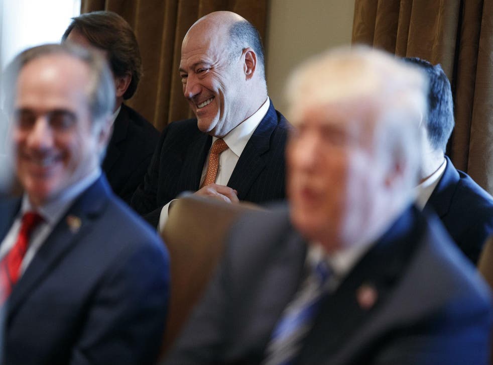 Outgoing White House chief economic adviser Gary Cohn laughs as President Donald Trump talks about him during a cabinet meeting at the White House