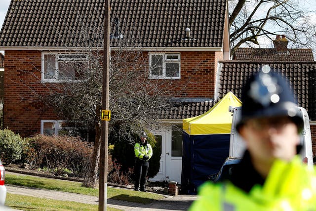 Police officers stand guard outside the home of Sergei Skripal in Salisbury,