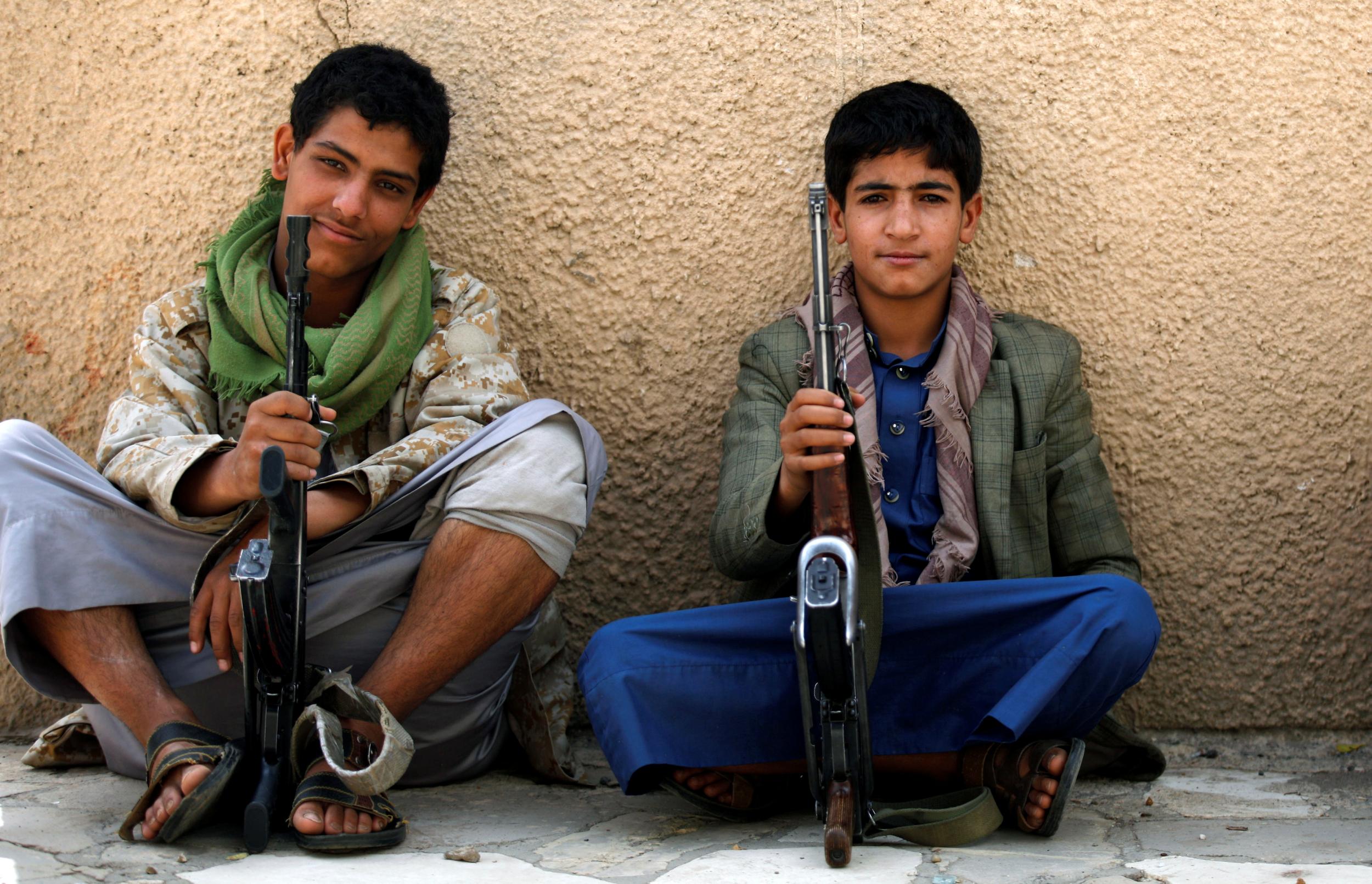 Young Houthi militants sit on the side of a road in Sanaa. Yemen is caught up in ‘a crisis where people feel like they have no choice but to fight to put bread on the table’