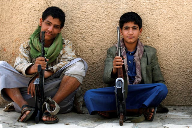 Young Houthi militants sit on the side of a road in Sanaa. Yemen is caught up in ‘a crisis where people feel like they have no choice but to fight to put bread on the table’