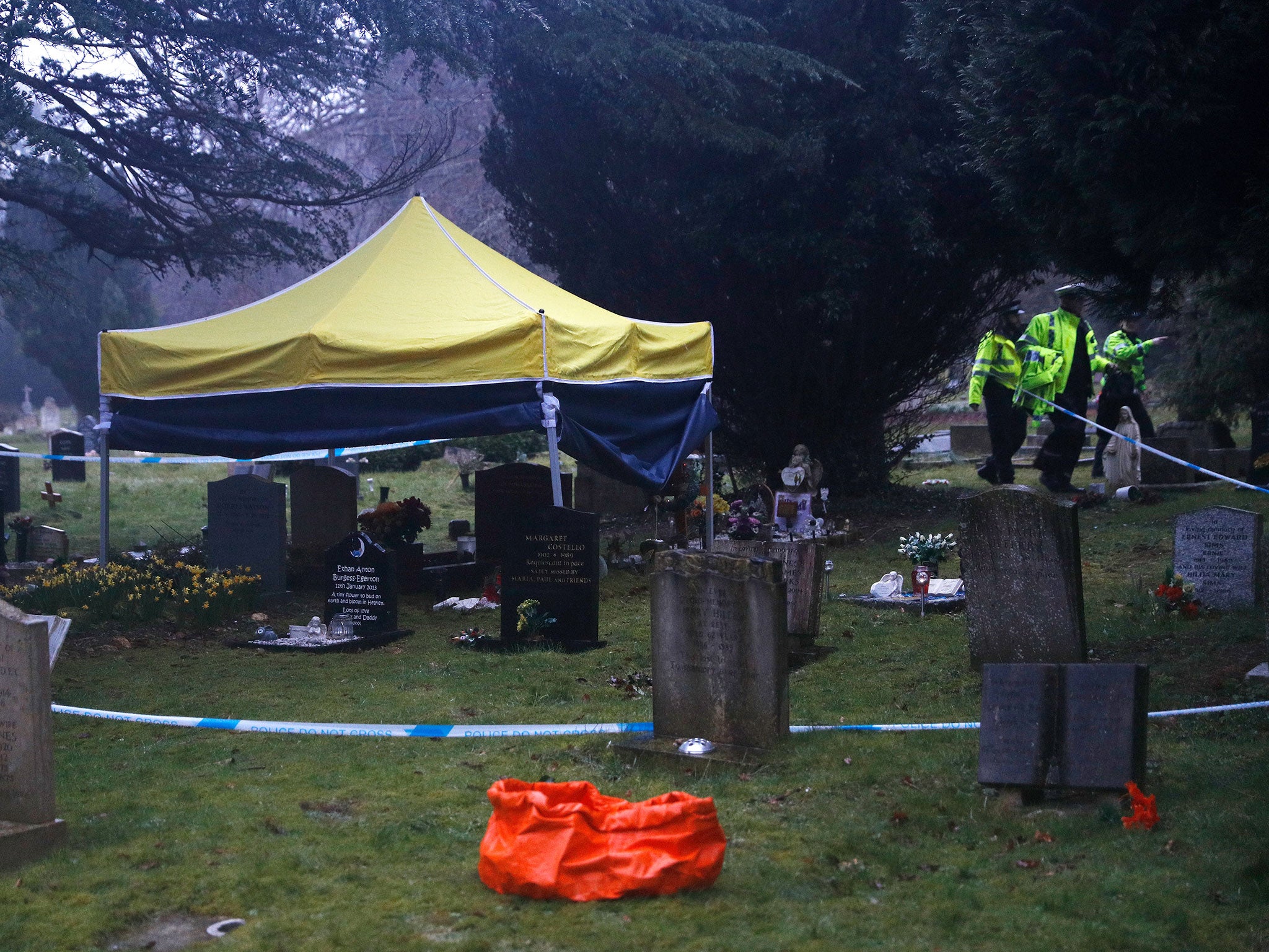 Police officers walk past a gazebo over the grave of Liudmila Skripal; the wife of former Russian spy Sergei Skripal; at the London Road cemetery in Salisbury,