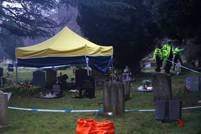 Police officers walk past a gazebo over the grave of Liudmila Skripal; the wife of former Russian spy Sergei Skripal; at the London Road cemetery in Salisbury,