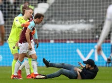 West Ham owners escorted from ground after pitch invasions from fans