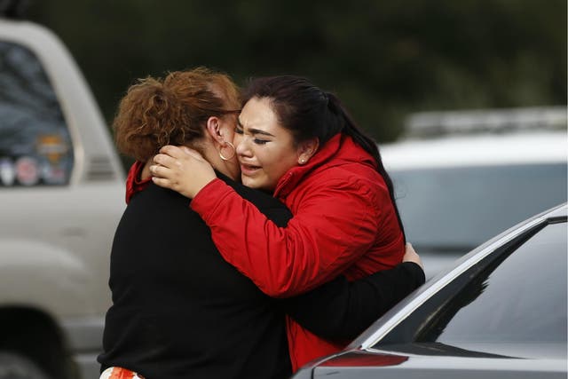 Vanessa Flores embraces another woman after she leaves the locked down Veterans Home of California during an active shooter turned hostage situation on 9 March 2018 in Yountville, California.