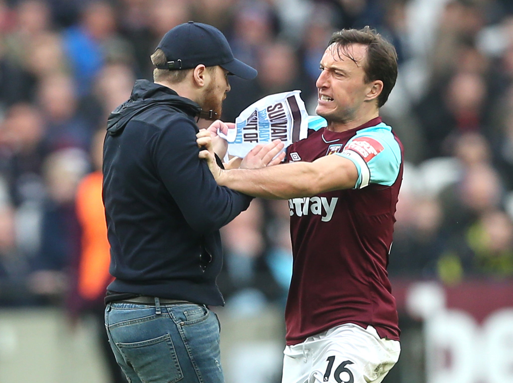 Mark Noble rowing with a pitch invader