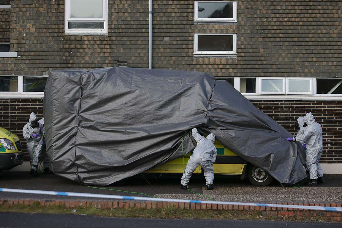 Personnel in protective coveralls and breathing equiptment cover an ambulance with a tarpaulin at the Salisbury District Hospital in Salisbury (AFP/Getty Images)