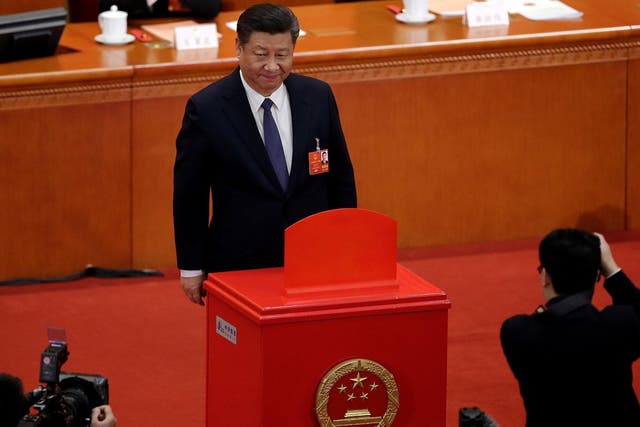Xi Jinping led members of th Communist Party's seven-member all-powerful Politburo Standing Committee in casting their votes on a constitutional amendment lifting presidential term limits