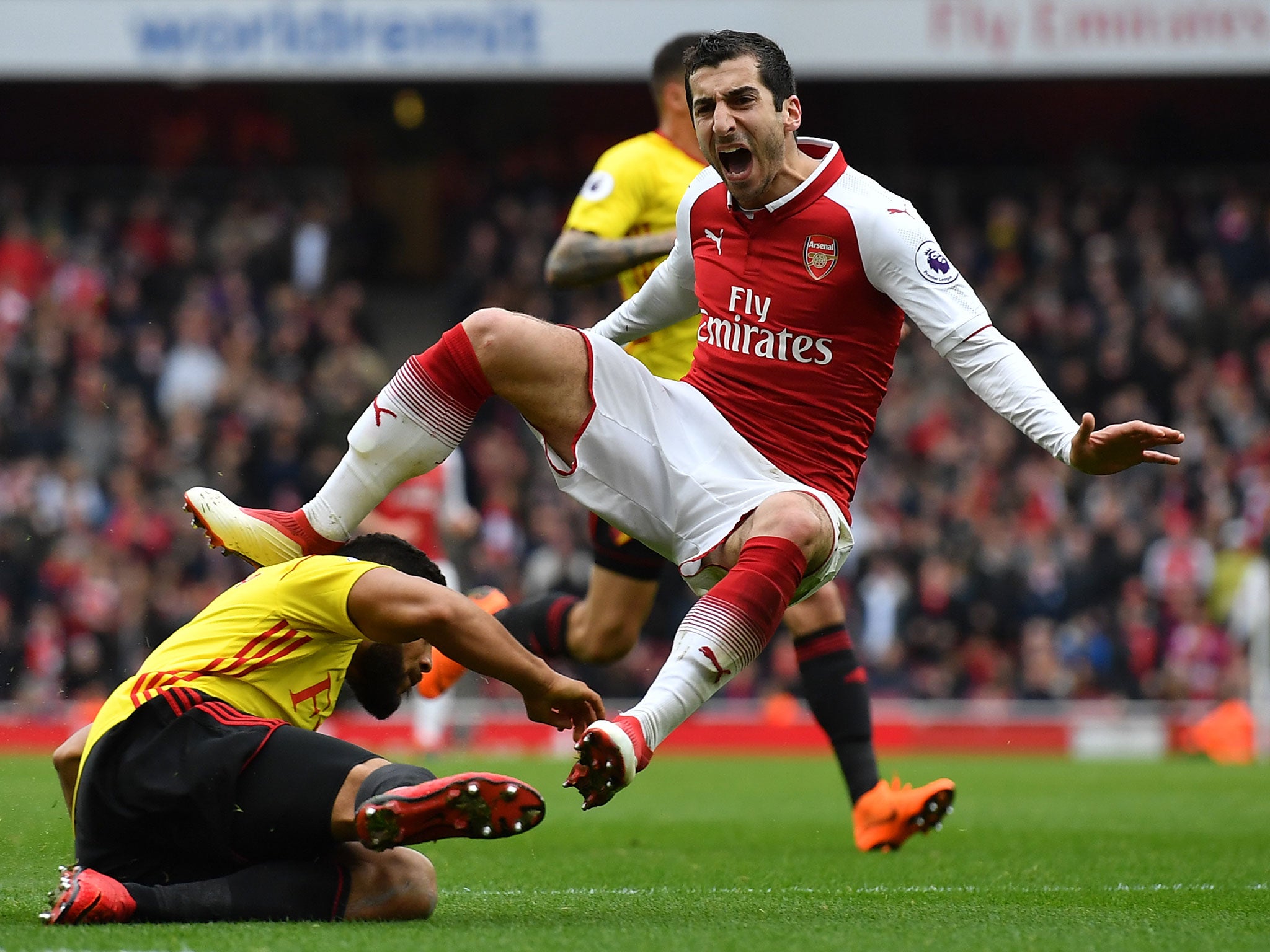 Henrikh Mkhitaryan is brought down by Adrian Mariappa