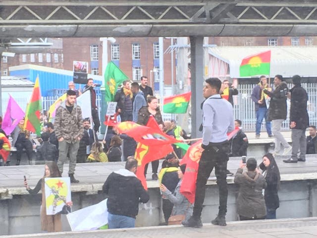 Campaigners holding flags gathered on the tracks and attempted to climb overhead cables, apparently in response to Turkey's war on Syrian Kurds