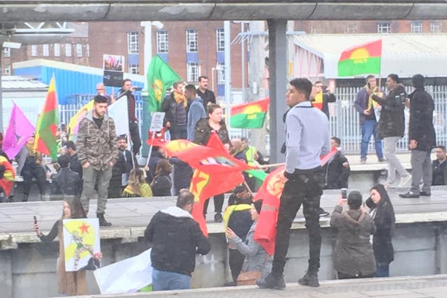Campaigners holding flags gathered on the tracks and attempted to climb overhead cables, apparently in response to Turkey's war on Syrian Kurds
