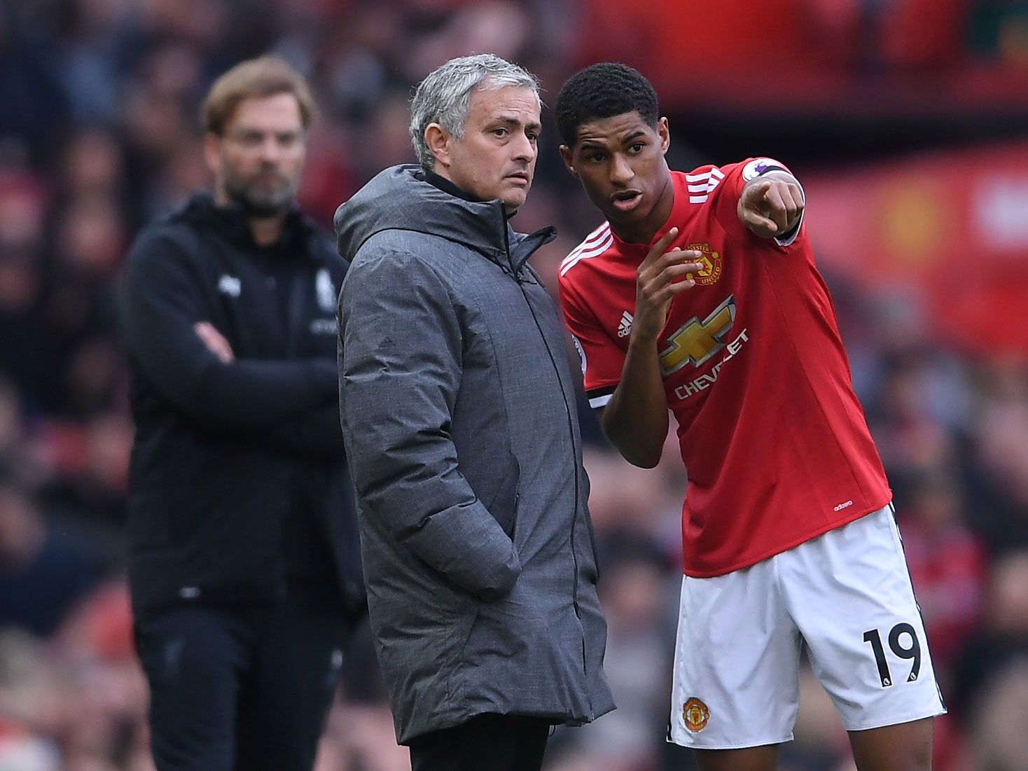 Marcus Rashford takes instructions from Jose Mourinho during the win over Liverpool