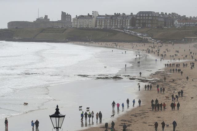 Families take walks along the beach at Tynemouth on Mother's Day. People across the UK enjoyed mostly mild weather on Sunday, but the outlook is expected to turn cold later in the week