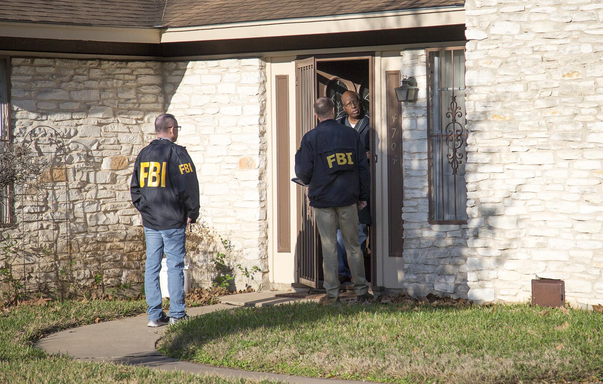 The FBI is pictured investigating the scene in East Austin, Texas, after a teenager was killed by a package explosion