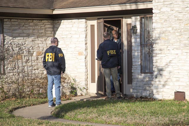 The FBI is pictured investigating the scene in East Austin, Texas, after a teenager was killed by a package explosion