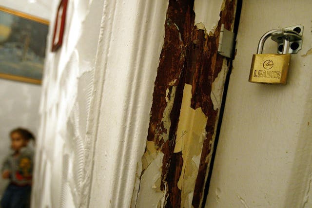 Lead paint peels off the wall of an apartment in New York City
