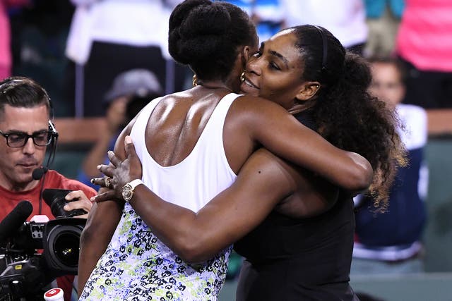 The Williams sisters embrace after Venus' victory over Serena at Indian Wells