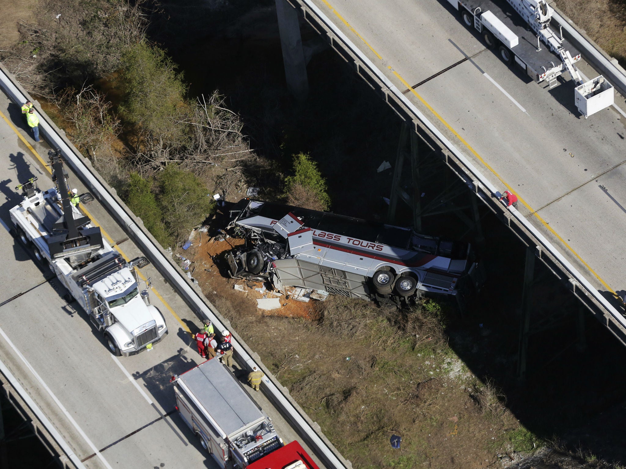 Rescue crews work at the scene of a deadly charter bus crash in Loxley, Alabama